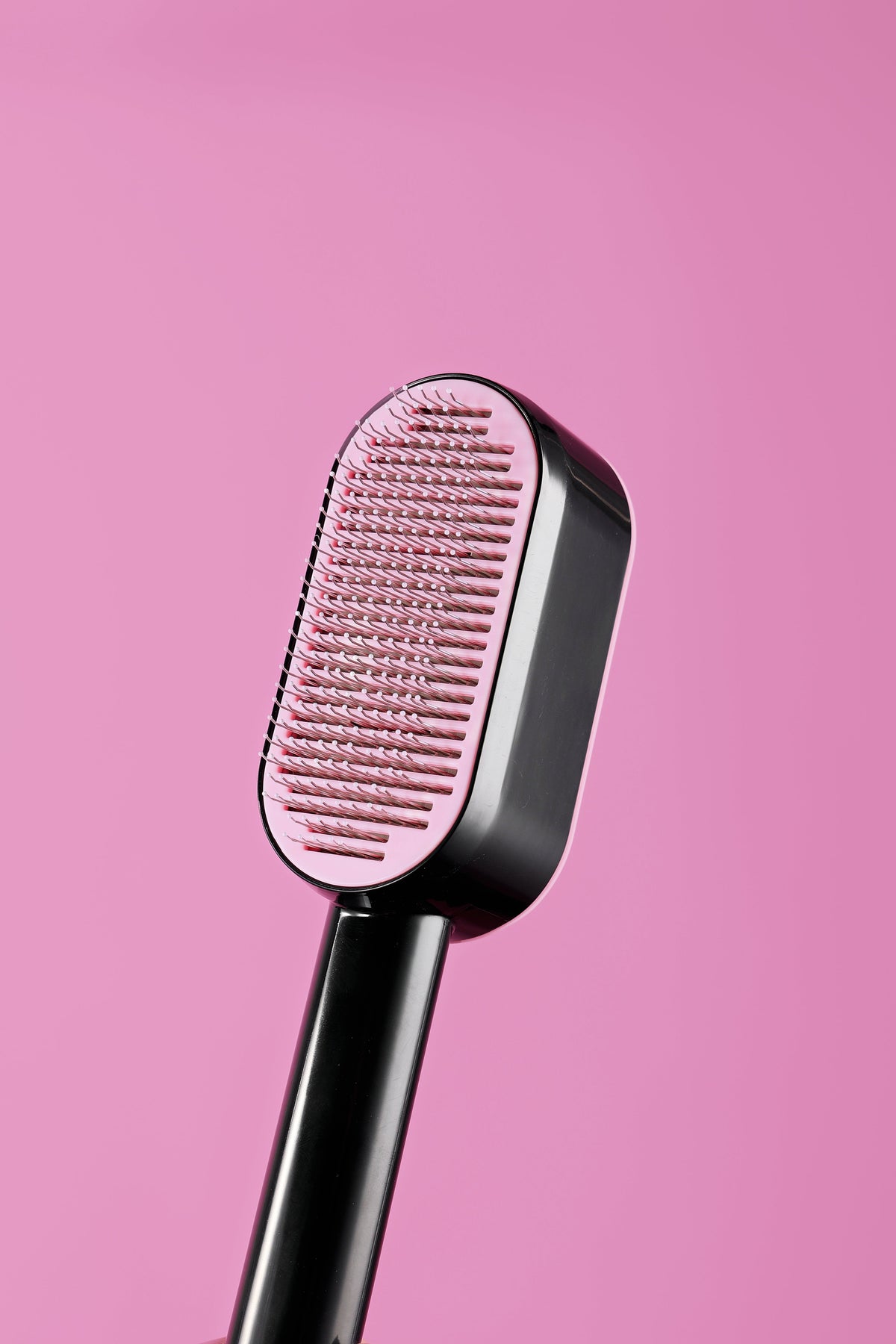 Self-cleaning pet brush in use