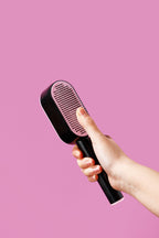 Push-button pet brush used on a dog's coat