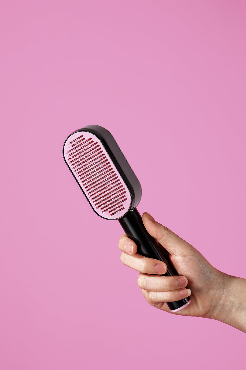 Black and pink push-button pet brush