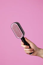 Black and pink push-button pet brush