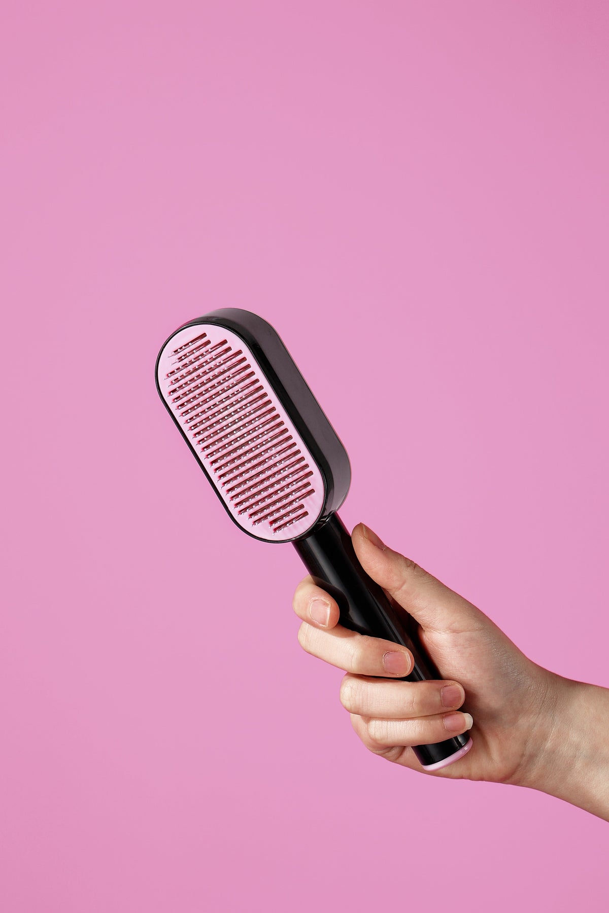 Black and pink push-button pet brush